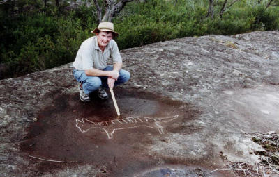Rex Gilroy Beside Aboriginal Carving of a Thylacine (Tasmanian Tiger)